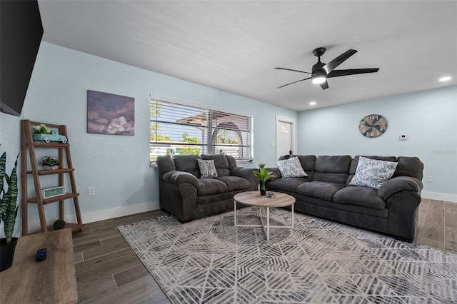 living room with ceiling fan and hardwood / wood-style flooring