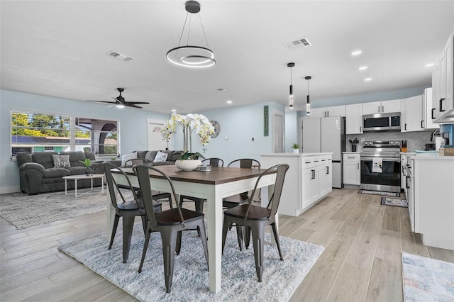 dining area featuring ceiling fan and light hardwood / wood-style flooring