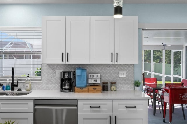 kitchen featuring white cabinets, sink, tasteful backsplash, and stainless steel dishwasher