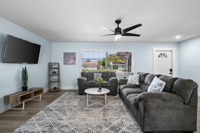 living room with ceiling fan, hardwood / wood-style flooring, and a textured ceiling