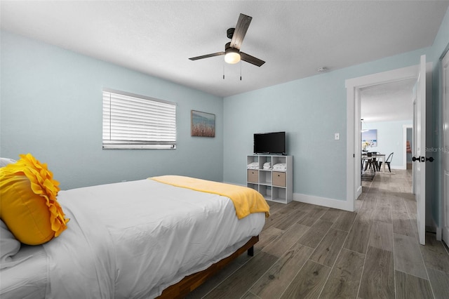 bedroom with ceiling fan and hardwood / wood-style flooring