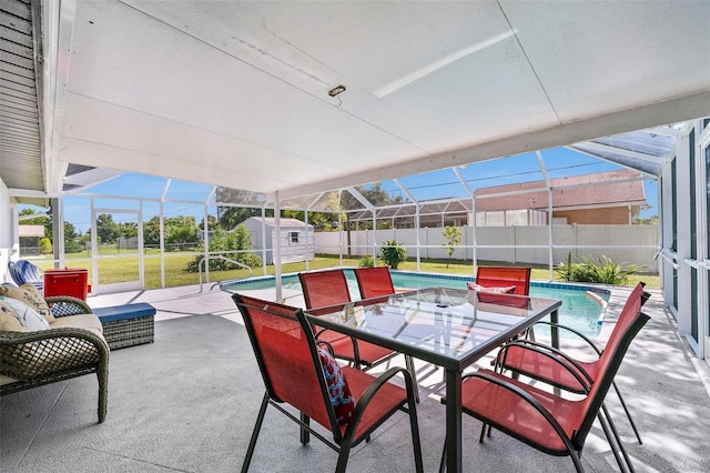 view of patio with a storage unit, a lanai, and a fenced in pool