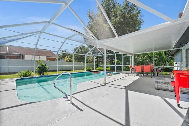 view of swimming pool with glass enclosure and a patio area