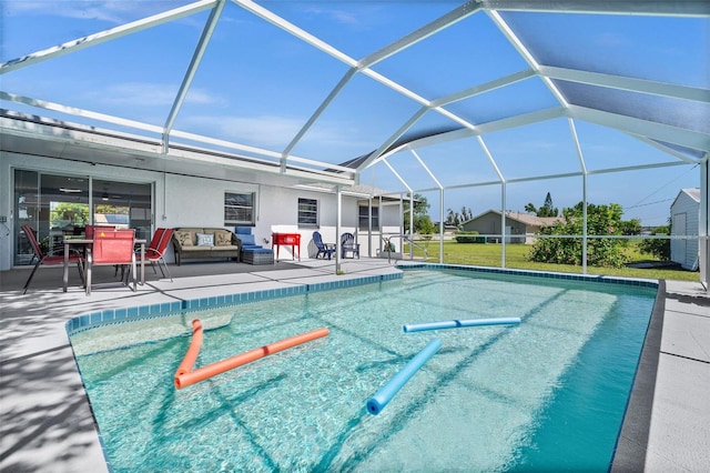 view of pool featuring a patio and glass enclosure