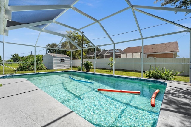 view of pool featuring a storage shed, glass enclosure, and a patio area