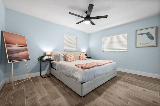 bedroom with ceiling fan and light hardwood / wood-style floors