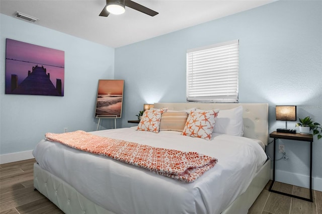 bedroom with hardwood / wood-style floors and ceiling fan