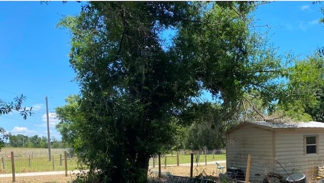 view of yard with a rural view