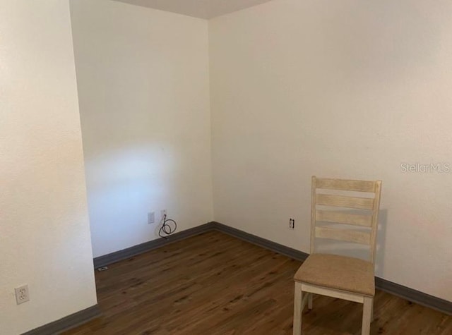 unfurnished room with dark hardwood / wood-style floors