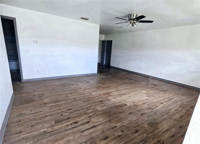 unfurnished room featuring ceiling fan and dark hardwood / wood-style floors