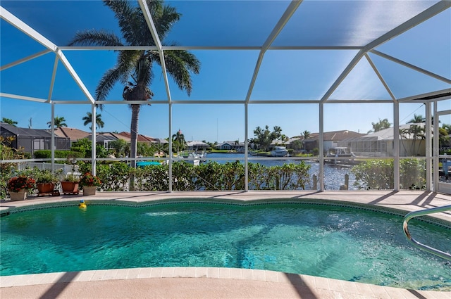 view of swimming pool with a water view, a patio, and a lanai