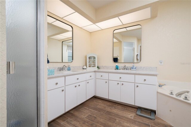 3730 Turtle Dove Blvd, Punta Gorda, FL 33950 - bathroom with wood finished floors, a sink, double vanity, and a stall shower