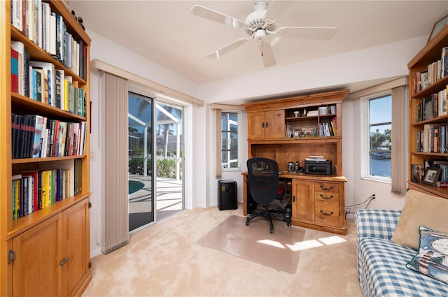 carpeted office with ceiling fan