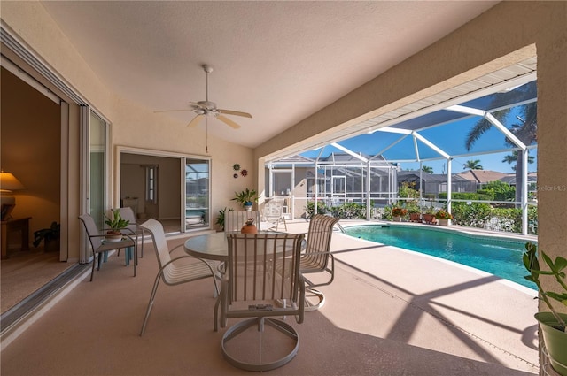 view of pool with a patio, a lanai, and ceiling fan