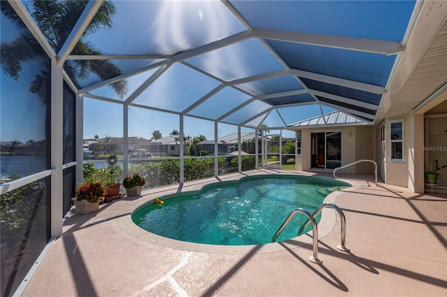 view of pool featuring a patio area, a lanai, and a water view