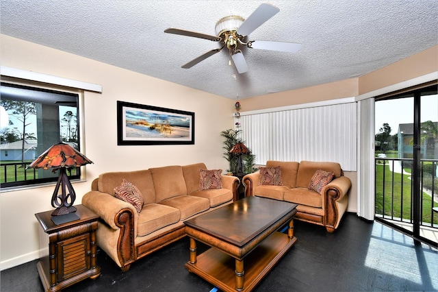 living room with a textured ceiling and ceiling fan