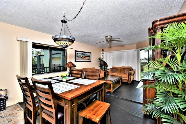 dining space with a textured ceiling and ceiling fan