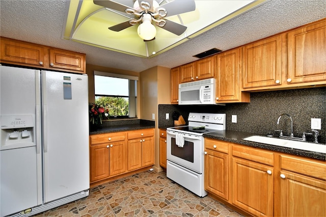 kitchen featuring sink, ceiling fan, a textured ceiling, white appliances, and tasteful backsplash