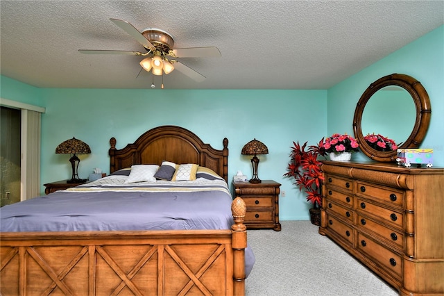 bedroom with a textured ceiling, carpet flooring, and ceiling fan