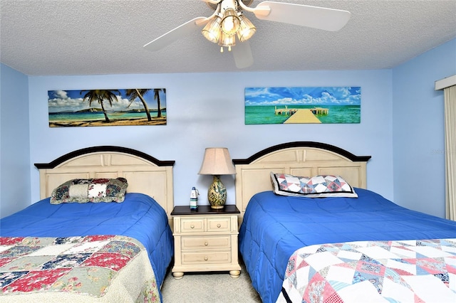 carpeted bedroom with ceiling fan and a textured ceiling