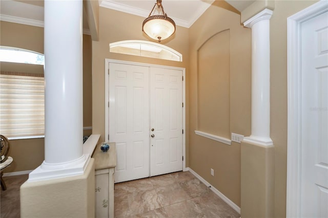 foyer with ornamental molding and ornate columns