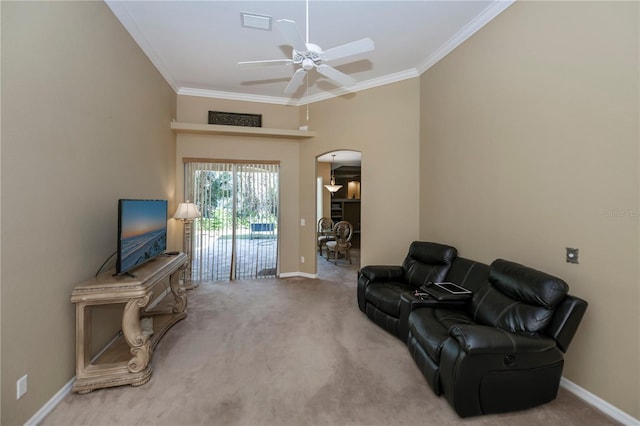 carpeted living room featuring crown molding, a high ceiling, and ceiling fan