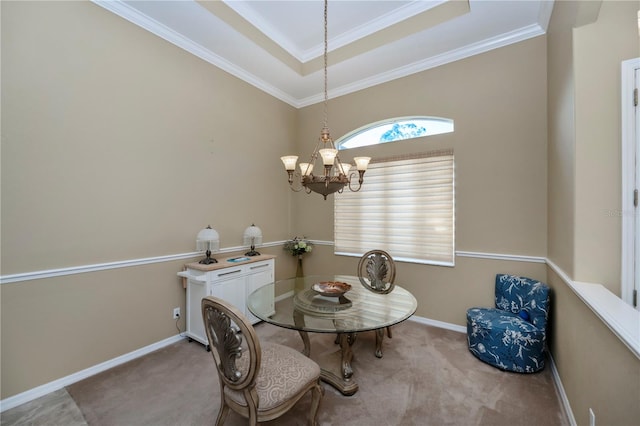 dining room with light carpet, crown molding, a chandelier, and a tray ceiling