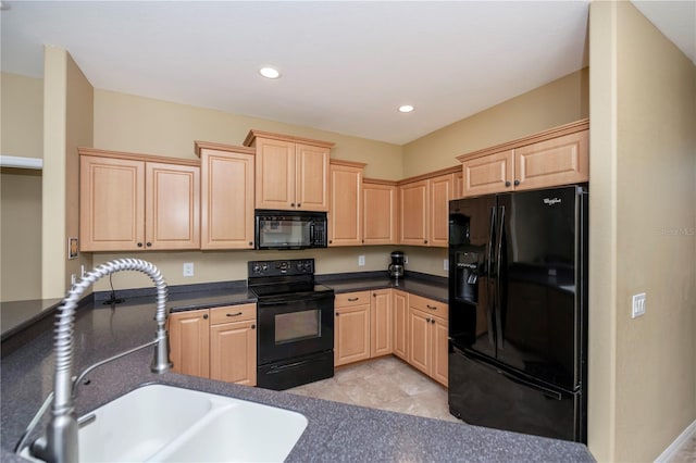 kitchen with black appliances, sink, light brown cabinetry, and light tile patterned floors