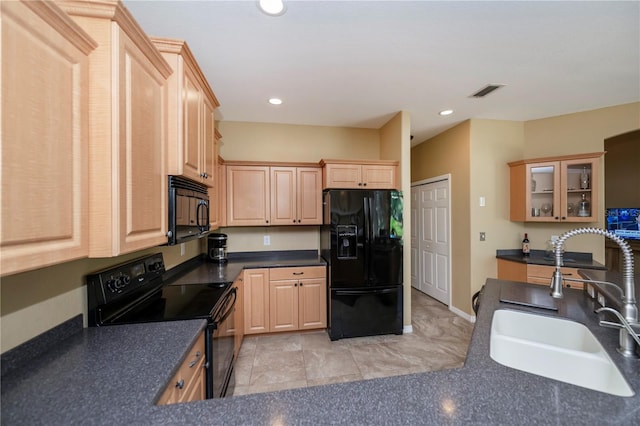 kitchen featuring light brown cabinetry, black appliances, and sink