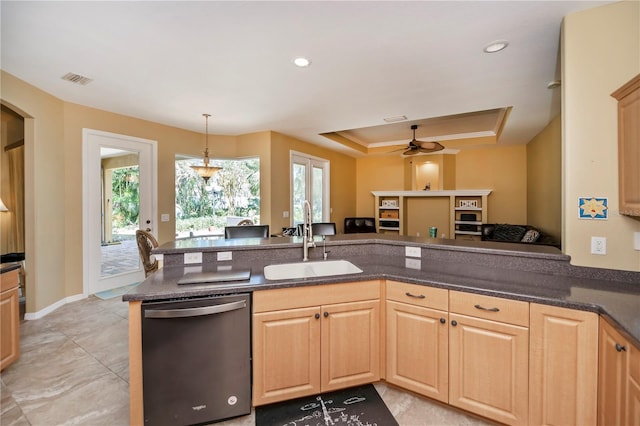 kitchen with stainless steel dishwasher, sink, kitchen peninsula, and decorative light fixtures