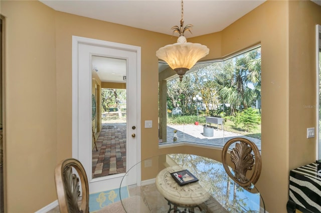 tiled dining space with a healthy amount of sunlight