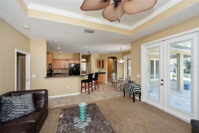 living room featuring sink, crown molding, french doors, and ceiling fan