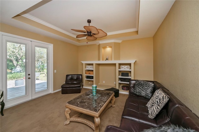 living room featuring french doors, carpet floors, a tray ceiling, and ceiling fan