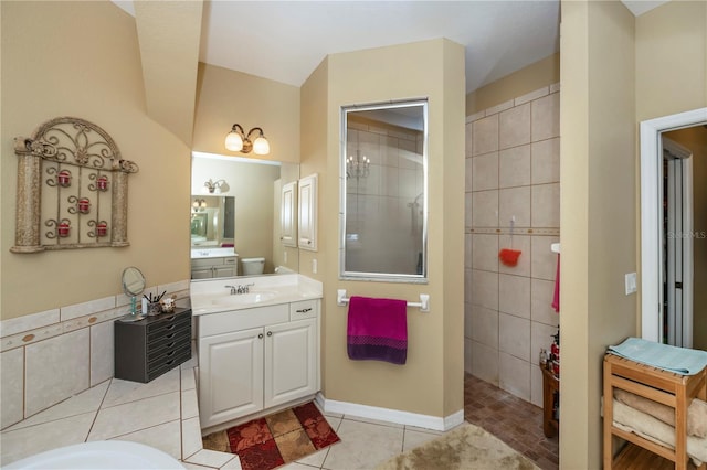 bathroom featuring vanity, a tile shower, and tile patterned floors