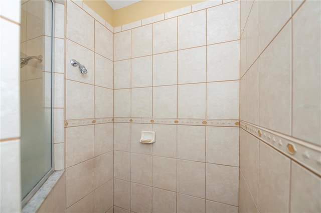 bathroom with a tile shower