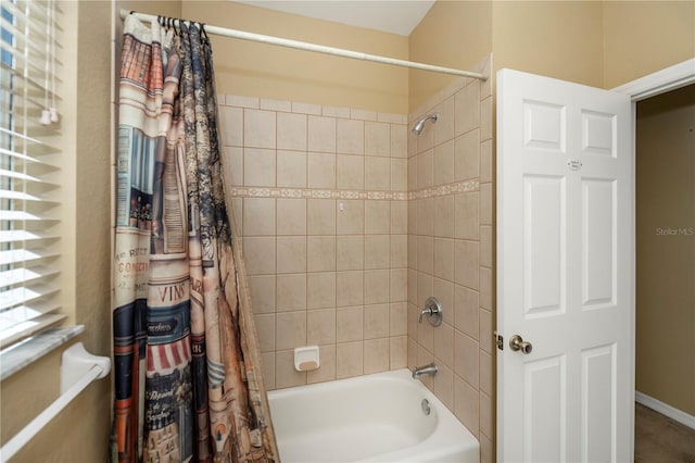 bathroom with shower / bath combo with shower curtain