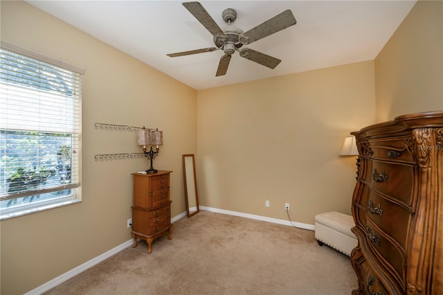 sitting room with light colored carpet and ceiling fan