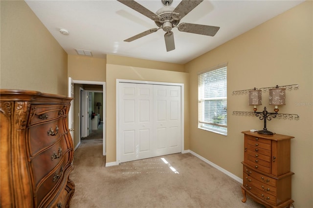 carpeted bedroom with a closet and ceiling fan