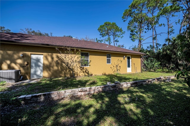 back of property featuring a yard and cooling unit