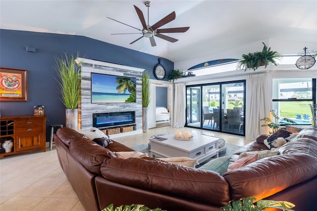 living room featuring lofted ceiling, ceiling fan, and light tile patterned floors