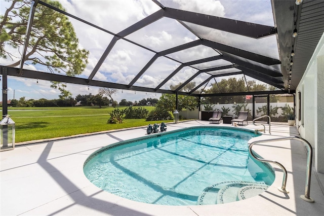 view of pool featuring a yard, a lanai, and a patio area