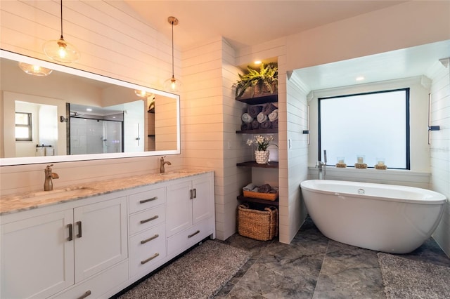 bathroom with wooden walls, vanity, plus walk in shower, and plenty of natural light