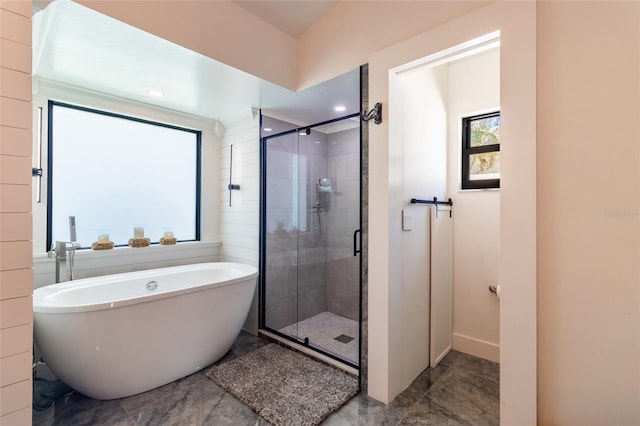 bathroom with shower with separate bathtub and plenty of natural light