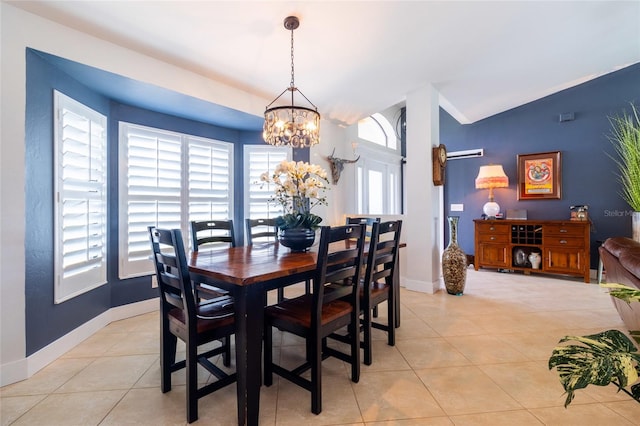 dining room with lofted ceiling, an inviting chandelier, light tile patterned floors, and plenty of natural light