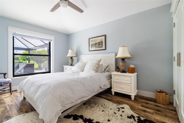 bedroom with ceiling fan and dark wood-type flooring