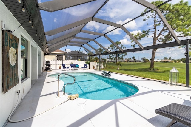 view of pool with glass enclosure, a patio area, and a yard