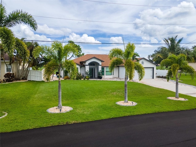 view of front facade with a garage and a front lawn