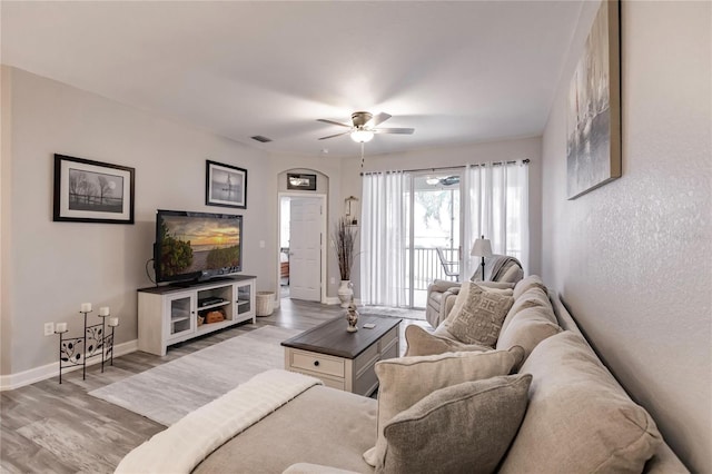 living room featuring hardwood / wood-style flooring and ceiling fan