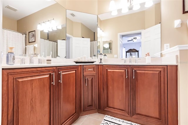 bathroom with tile patterned flooring, curtained shower, vanity, and ceiling fan