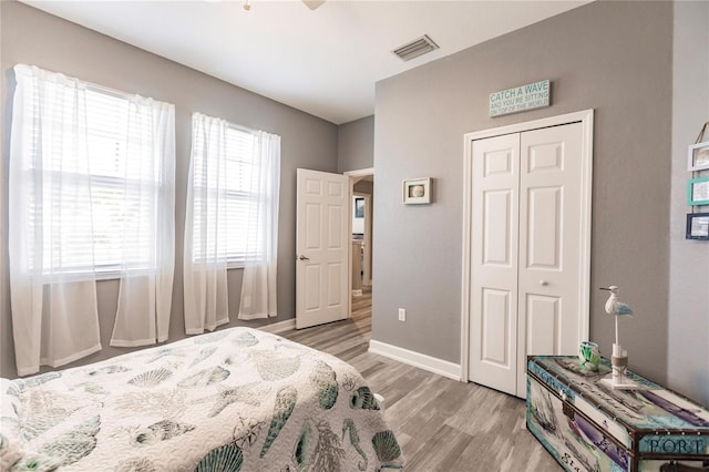 bedroom with a closet and light hardwood / wood-style flooring